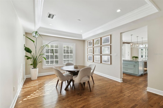 dining space featuring dark hardwood / wood-style flooring, beverage cooler, and crown molding