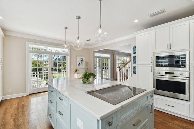 kitchen with white cabinets, french doors, a center island, and black electric cooktop