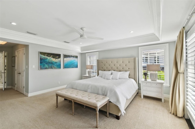 bedroom featuring a tray ceiling, ceiling fan, light carpet, and ornamental molding