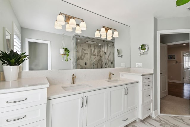 bathroom with vanity and a shower with door