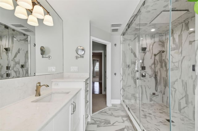 bathroom featuring vanity, a shower with shower door, and an inviting chandelier