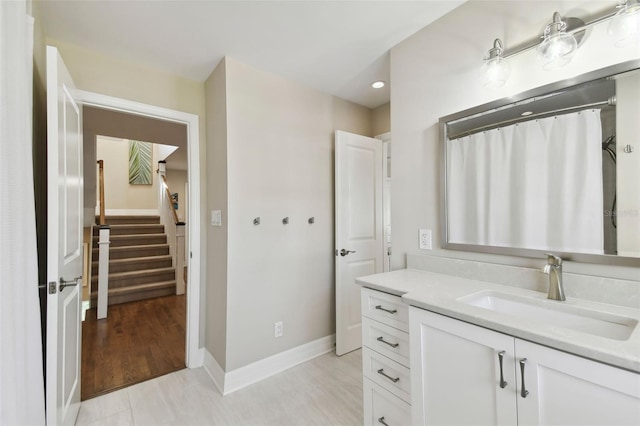 bathroom featuring hardwood / wood-style floors, vanity, and a shower with shower curtain