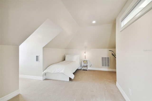 carpeted bedroom featuring vaulted ceiling