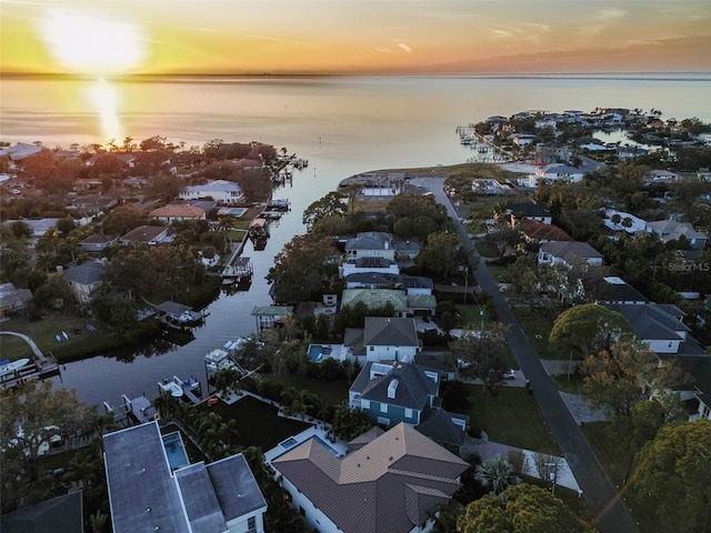 aerial view at dusk with a water view