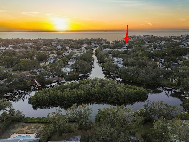 aerial view at dusk with a water view