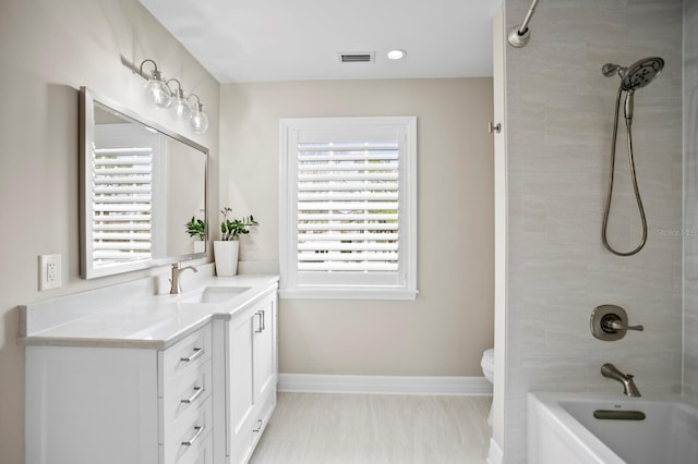 full bath with bathing tub / shower combination, visible vents, toilet, vanity, and baseboards