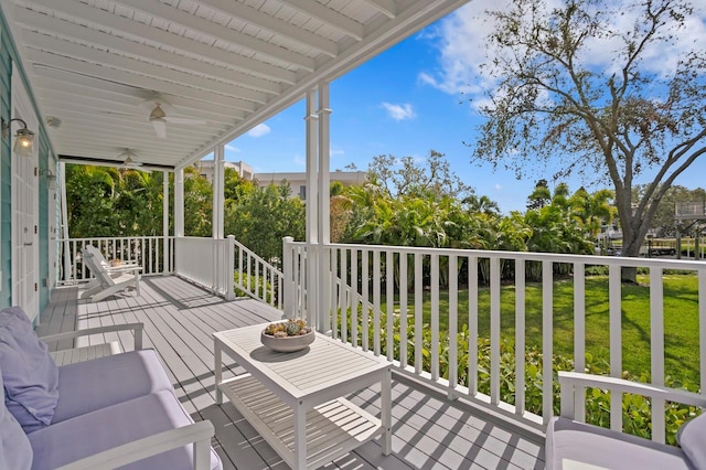 wooden deck with a ceiling fan and a yard