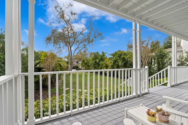 wooden deck featuring a yard