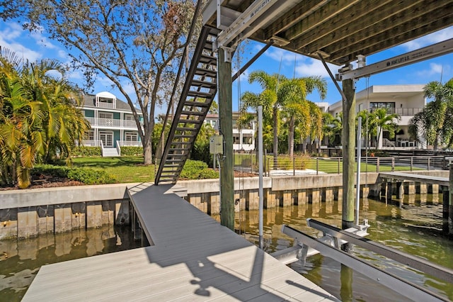 dock area with a water view, stairway, and boat lift