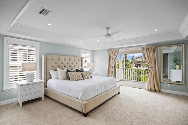 bedroom with visible vents, light colored carpet, access to exterior, a tray ceiling, and crown molding