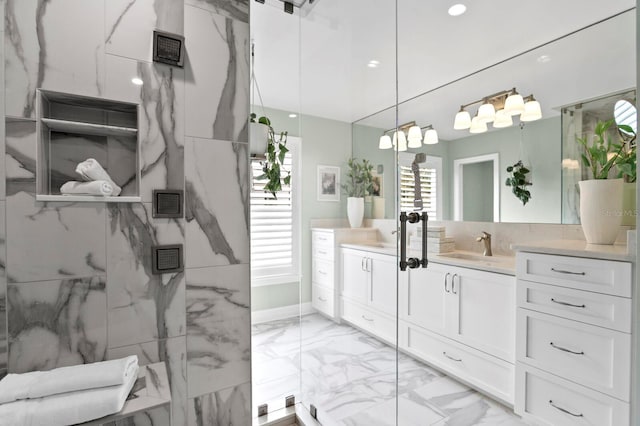 bathroom featuring marble finish floor, vanity, and a marble finish shower