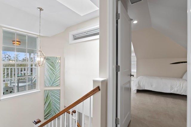 bedroom featuring vaulted ceiling, carpet floors, and a notable chandelier