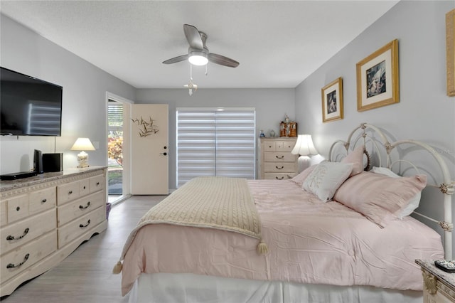 bedroom with access to outside, ceiling fan, a textured ceiling, and light wood-type flooring