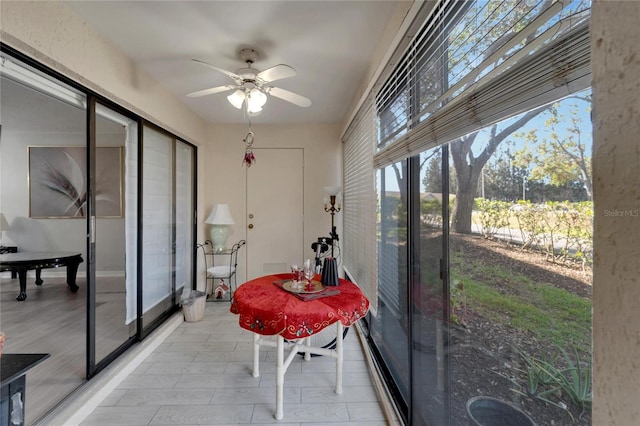 sunroom / solarium featuring ceiling fan