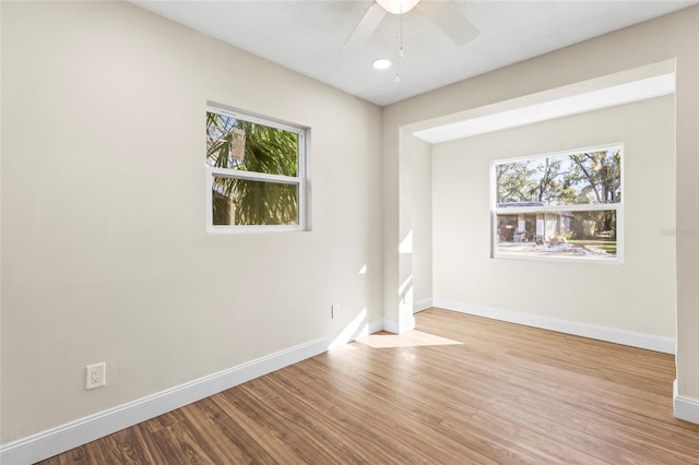 unfurnished room featuring light wood-type flooring and ceiling fan