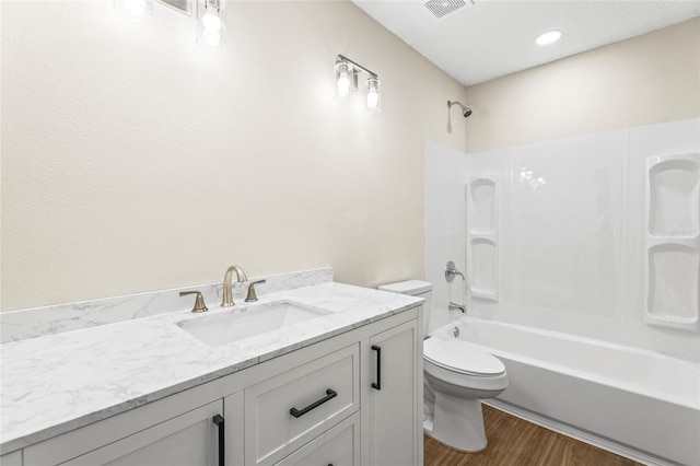 full bathroom featuring toilet, vanity, shower / tub combination, and hardwood / wood-style floors