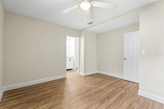 empty room featuring ceiling fan and wood-type flooring