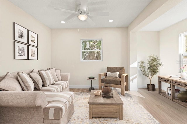 living room featuring ceiling fan and light wood-type flooring