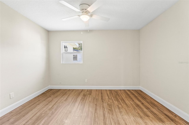 spare room featuring a textured ceiling, ceiling fan, and hardwood / wood-style flooring