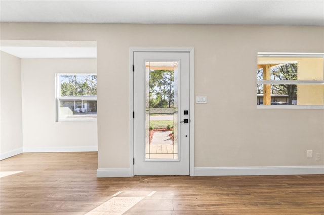 doorway to outside featuring hardwood / wood-style floors and plenty of natural light