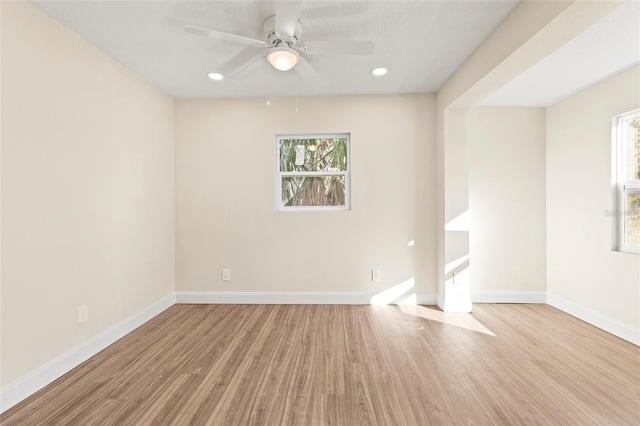 empty room featuring ceiling fan and light hardwood / wood-style floors