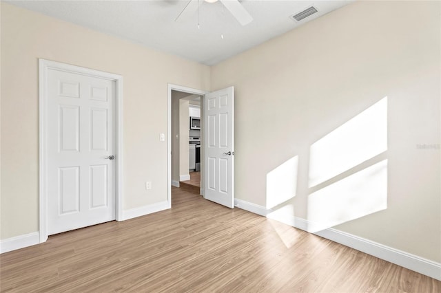 spare room with ceiling fan and light hardwood / wood-style flooring