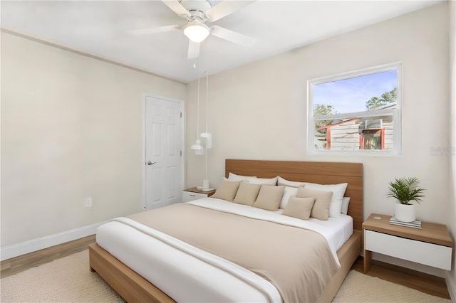 bedroom with ceiling fan and light hardwood / wood-style flooring