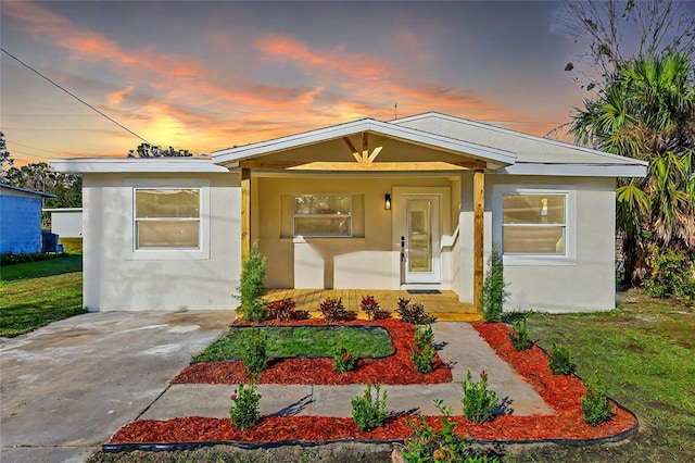 bungalow-style house featuring a porch and stucco siding