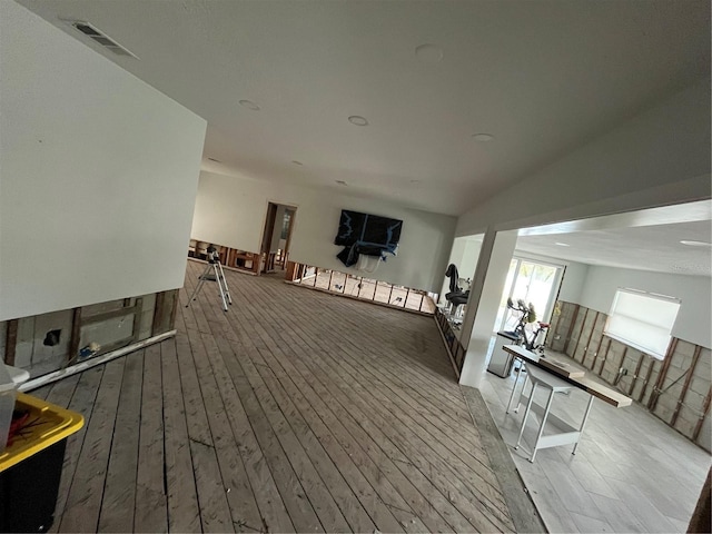 interior space featuring hardwood / wood-style floors and lofted ceiling