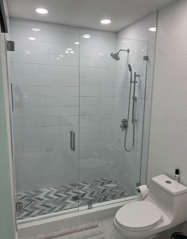 full bath featuring toilet and a shower stall