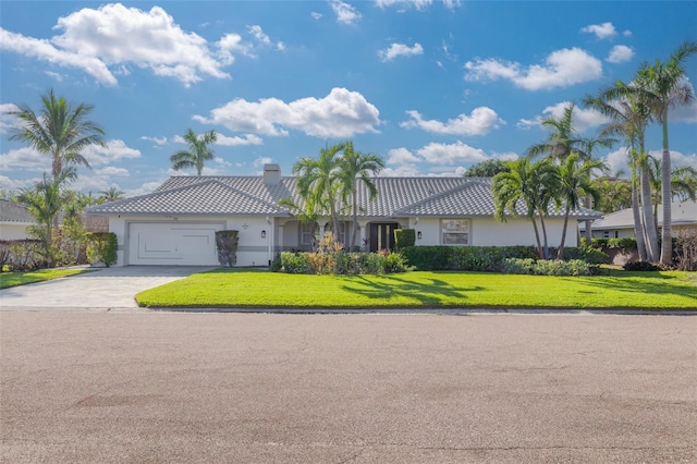 view of front of house featuring a garage and a front lawn