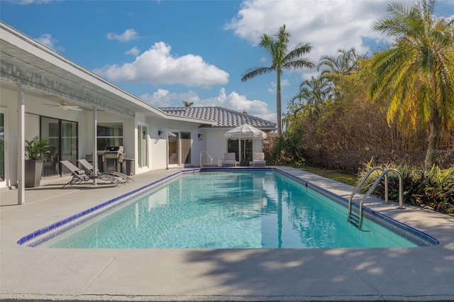 view of pool with a patio area, ceiling fan, and area for grilling