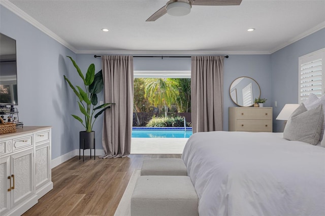 bedroom with access to outside, multiple windows, ceiling fan, and hardwood / wood-style floors