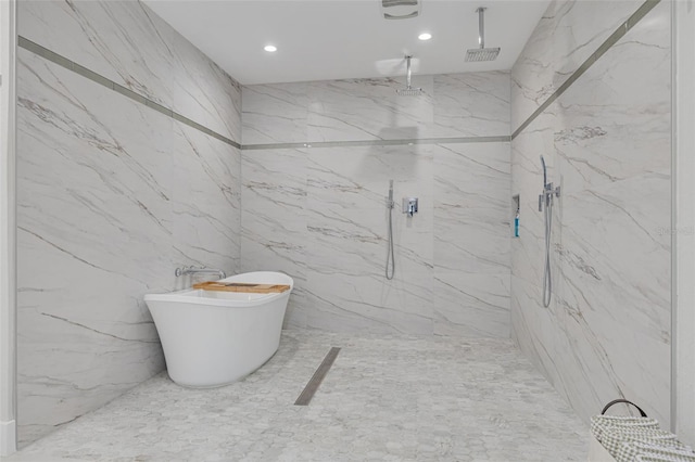 bathroom featuring separate shower and tub and tile walls