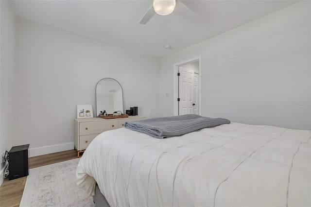 bedroom with light hardwood / wood-style floors and ceiling fan