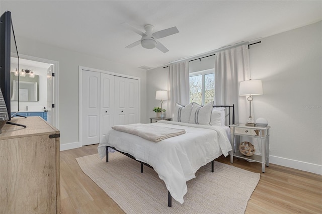 bedroom with a closet, light hardwood / wood-style flooring, and ceiling fan