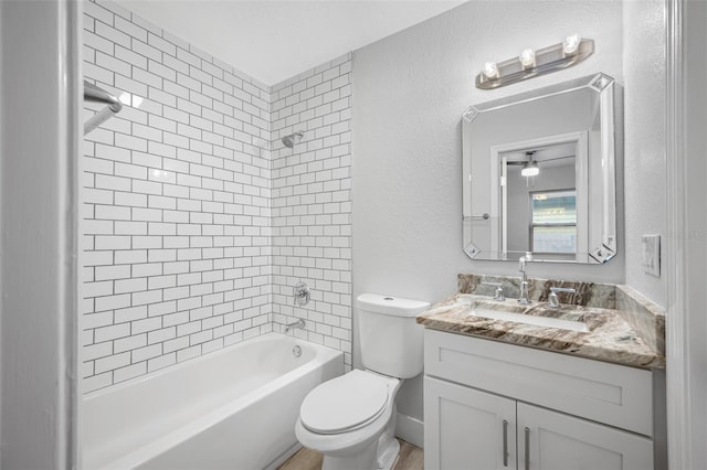 full bathroom featuring vanity, toilet, and tiled shower / bath