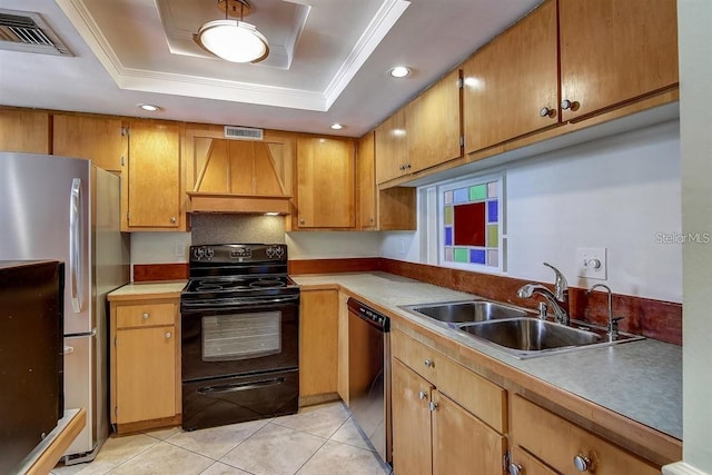 kitchen featuring a tray ceiling, sink, custom range hood, and black appliances