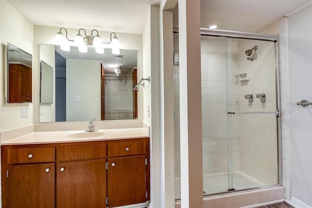 bathroom with walk in shower and vanity