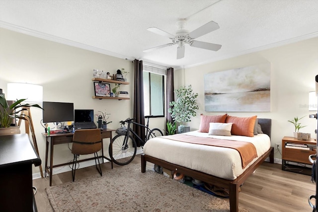 bedroom featuring crown molding, ceiling fan, a textured ceiling, and light hardwood / wood-style flooring