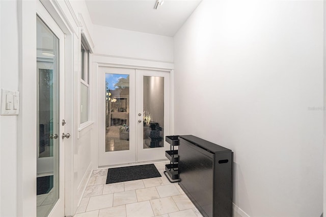 doorway featuring light tile patterned flooring and french doors