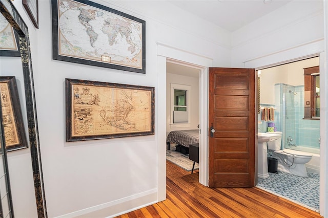 hallway with hardwood / wood-style floors