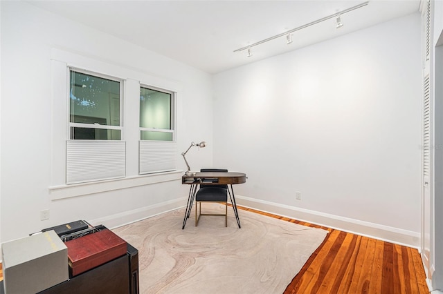 interior space featuring track lighting and hardwood / wood-style flooring