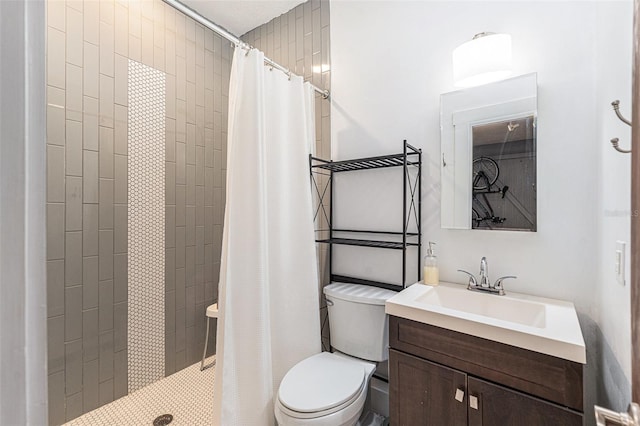 bathroom with vanity, curtained shower, and toilet