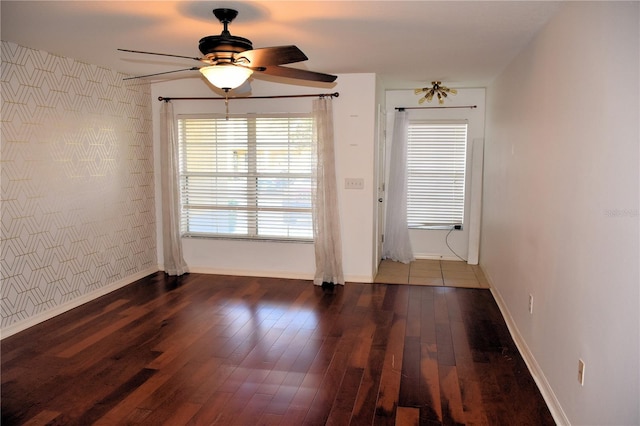 unfurnished dining area featuring ceiling fan and dark hardwood / wood-style flooring