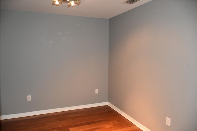 spare room featuring dark hardwood / wood-style floors