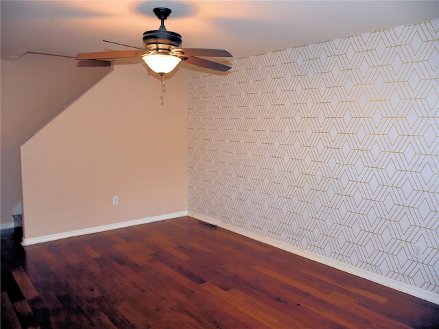 spare room with dark wood-type flooring and ceiling fan