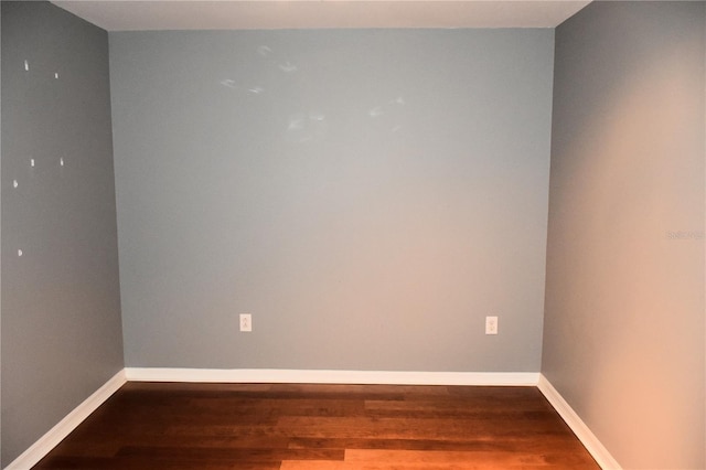 spare room with hardwood / wood-style flooring