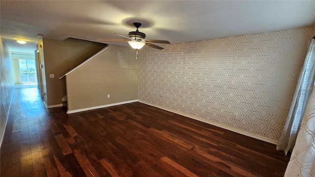 empty room featuring ceiling fan and dark hardwood / wood-style flooring