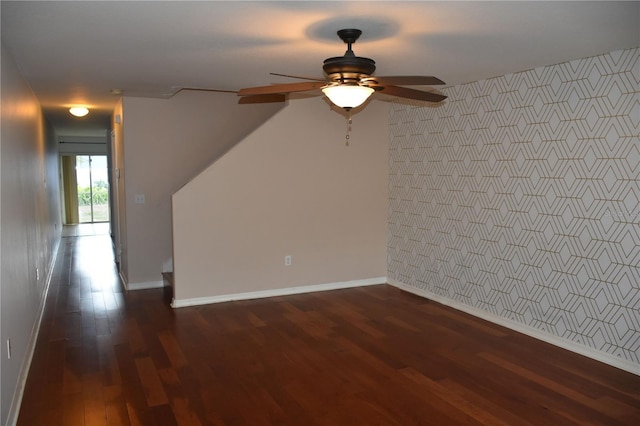 empty room with dark wood-type flooring and ceiling fan